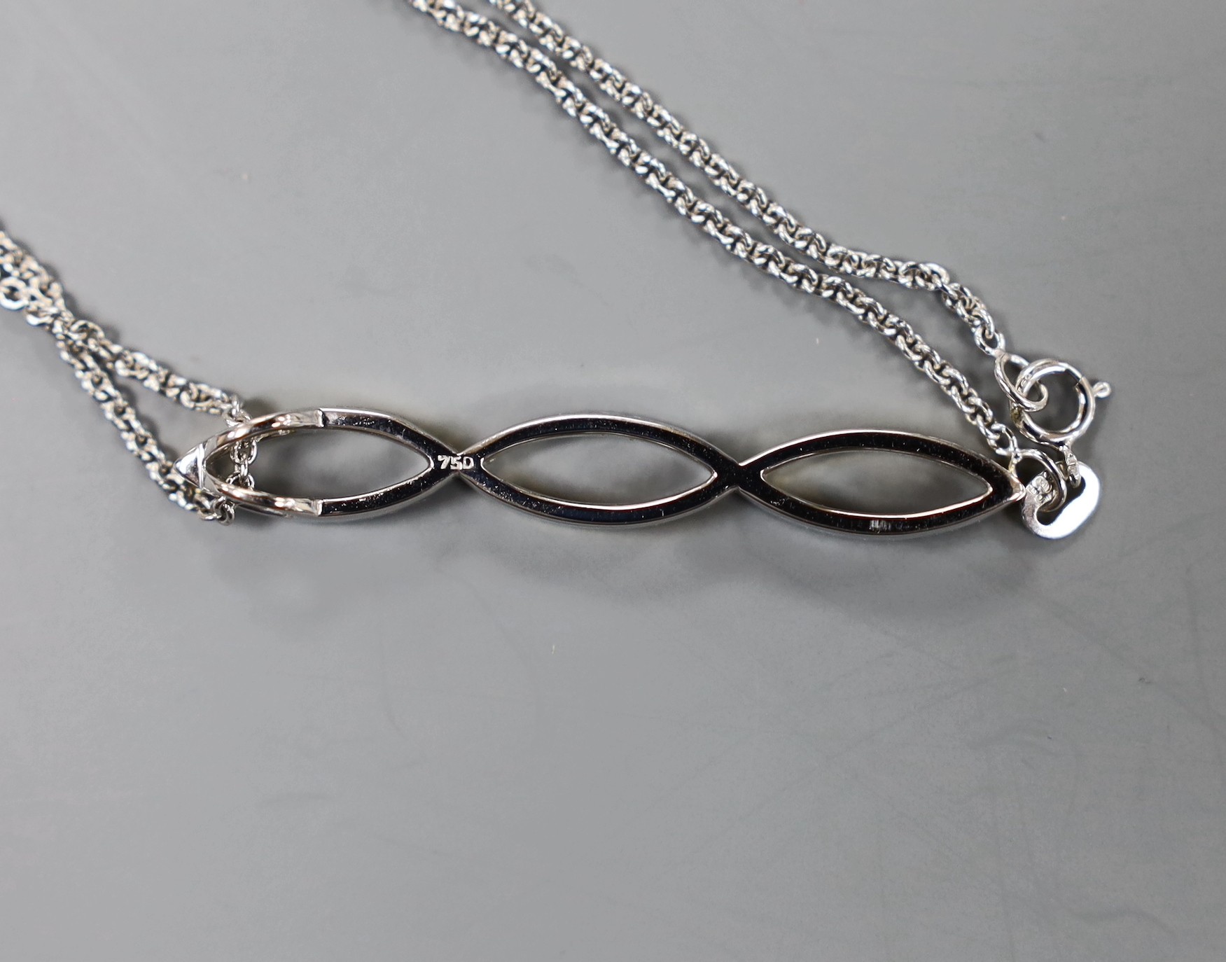 A modern two colour 18ct gold and two colour diamond set overlapping pendant, 42mm, on an 18ct white gold fine link chain, 40cm, 6.9 grams